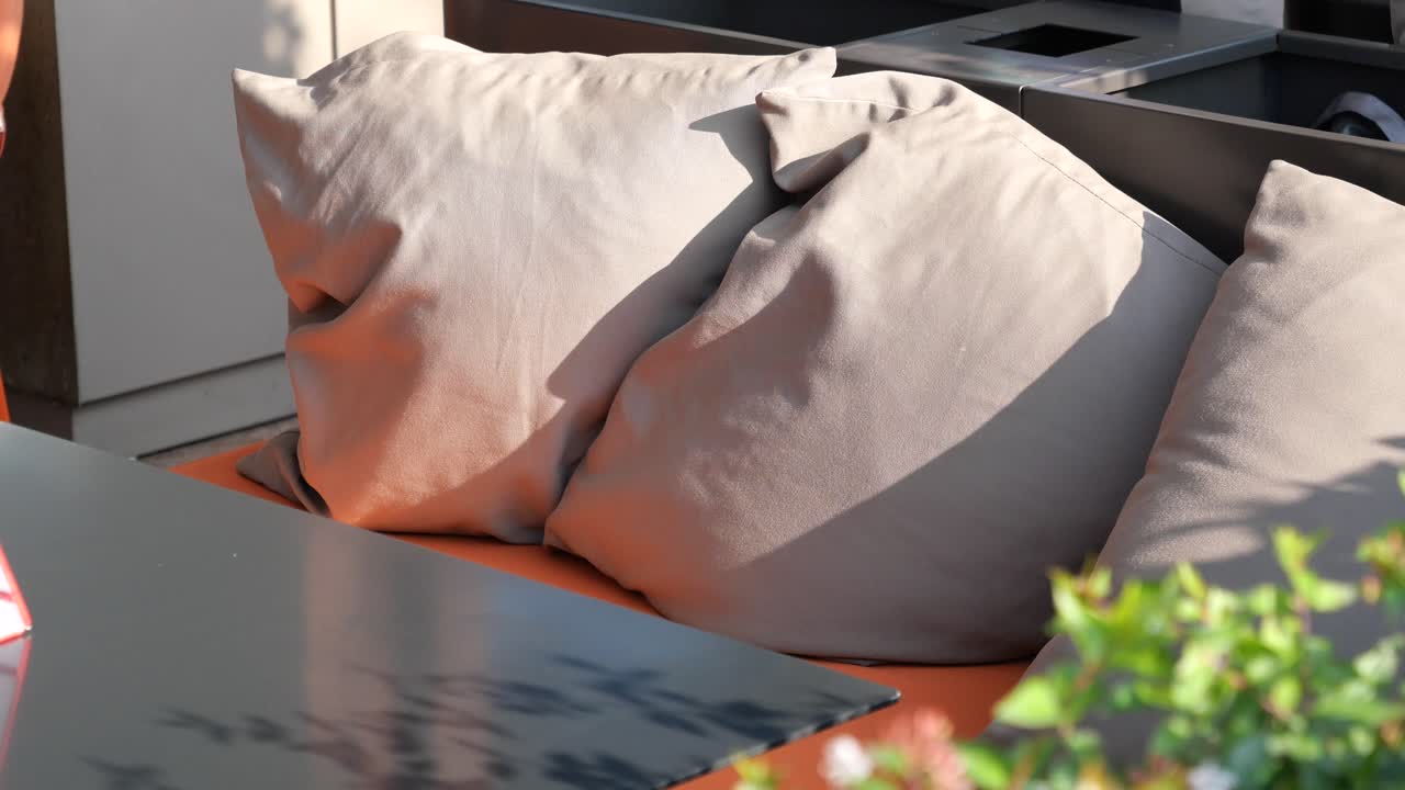 Outdoor patio seating with beige pillows