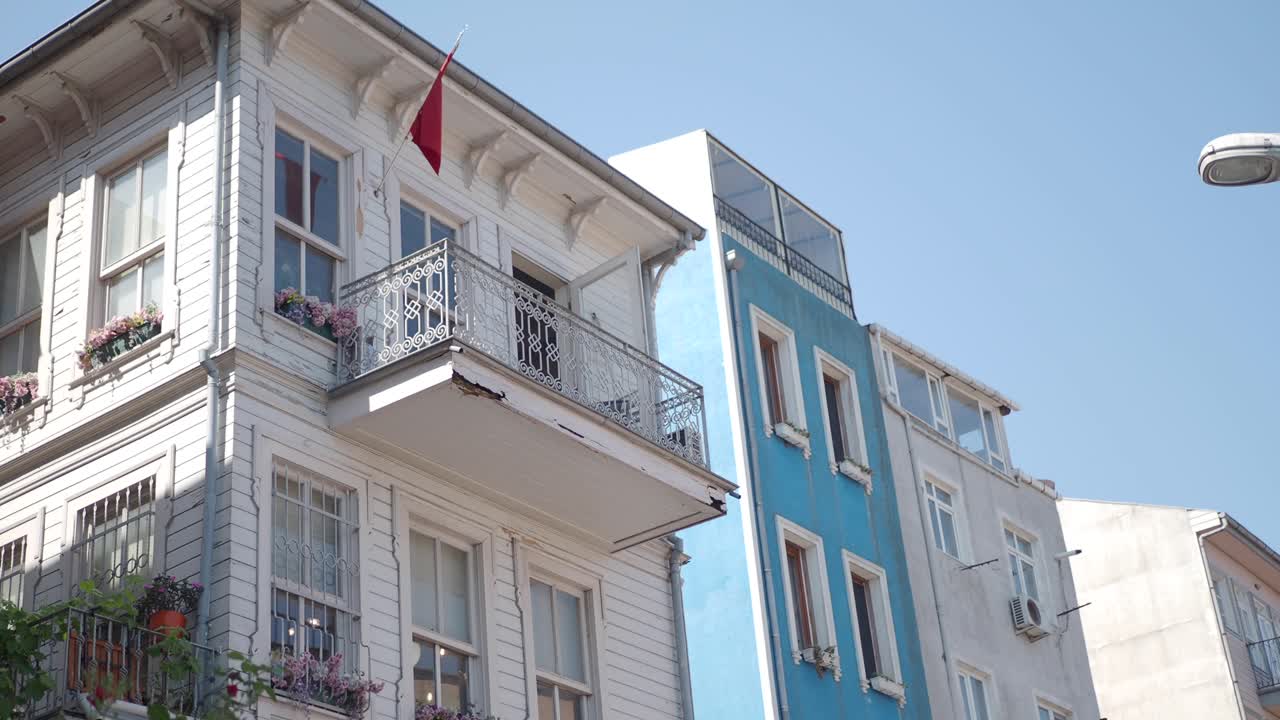 un edificio blanco con un balcón y una bandera roja