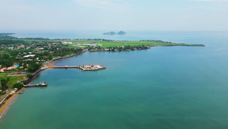 aerial tracking shot of the ana chavez bay with the sao tome airport in the background