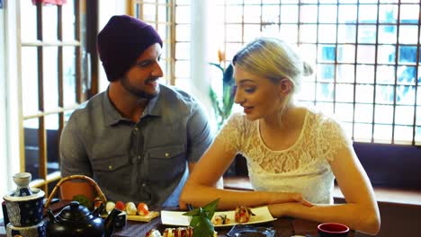 couple interacting with each other in restaurant