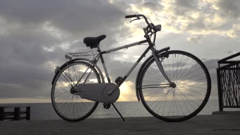 vintage '80s touring bicycle by the sea with sunset in the back slow motion 120 fps - orbiting side shot