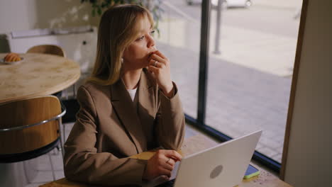 a woman working on her laptop in a cafe