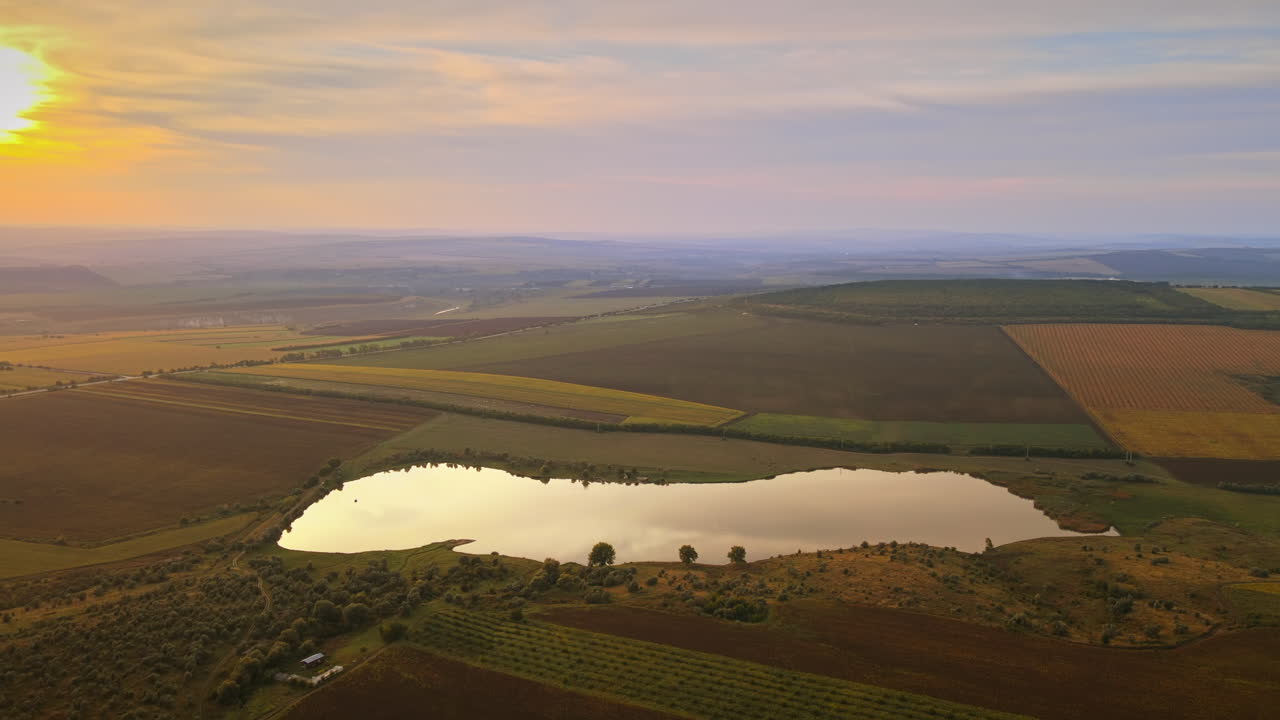 Aerial drone view of nature in Moldova at sunset. Lake, wide fields