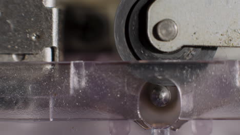 extreme close-up of microcassette pinch roller spinning
