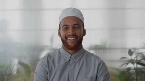portrait-young-muslim-businessman-smiling-enjoying-professional-career-success-mixed-race-entrepreneur-wearing-kufi-hat-in-office