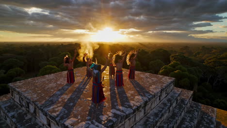 mayan ritual ceremony on ancient pyramid at sunset