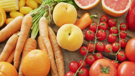 video of fresh fruit and vegetables over wooden background