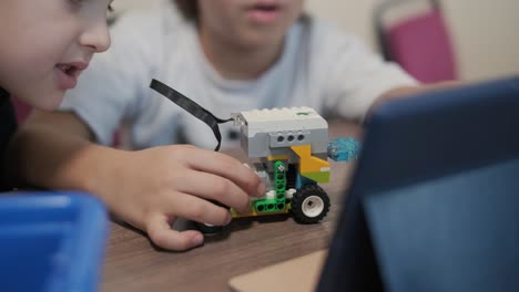 children engage in stem learning activities, assembling robotics kits with focus and teamwork in a classroom setting