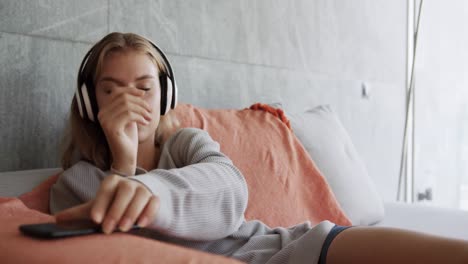 Caucasian-woman-listening-to-music-in-hotel-room