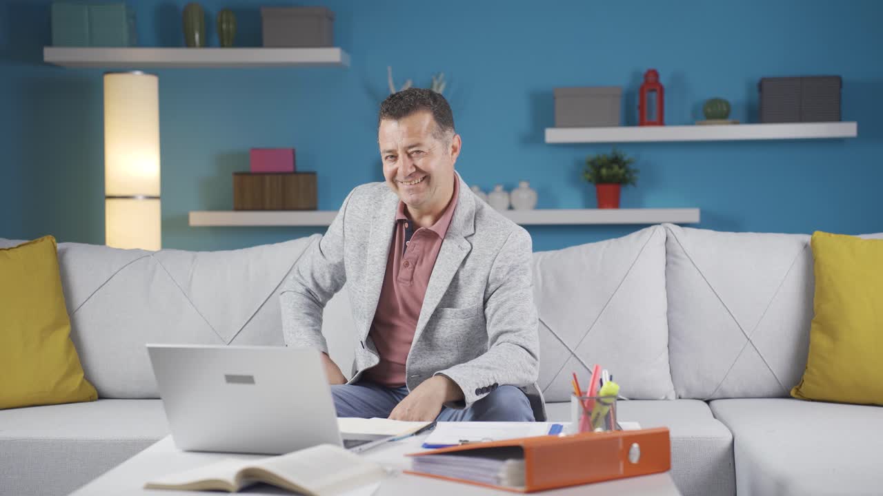 Home office worker man winks at camera.