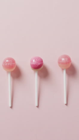 video of pink lollipops on pink background