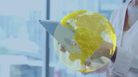 animation of globe over caucasian businesswoman using tablet