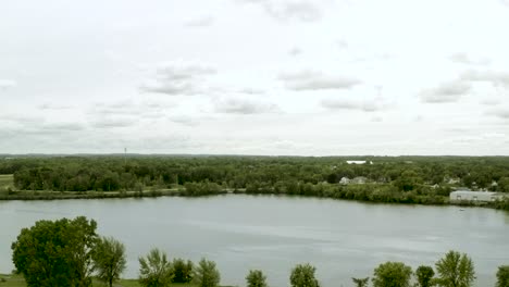 Drone-video-revealing-the-Fox-River-in-Little-Chute,-Wisconsin-on-a-cloudy-summer-day