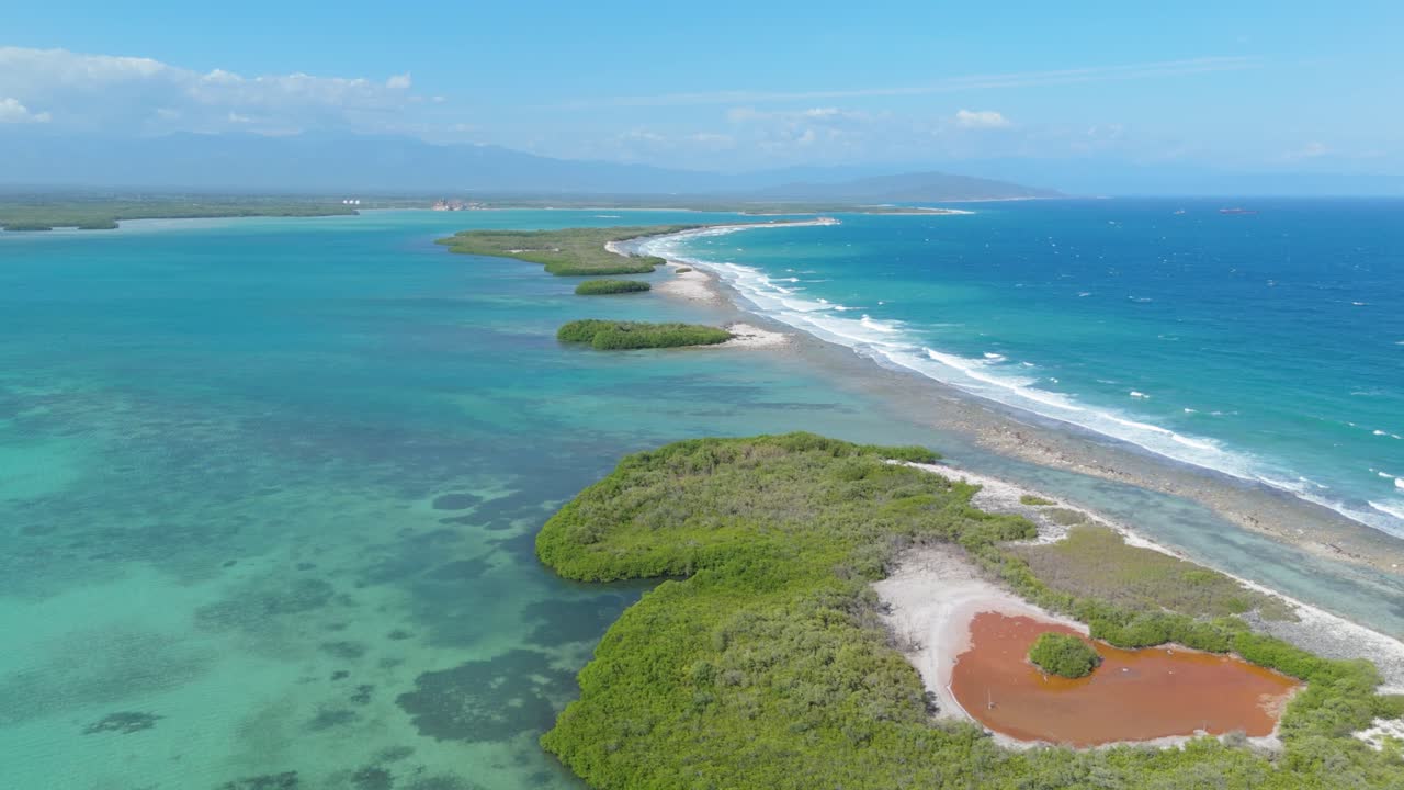 Small green island in the bay of Playa Caobita in the Dominican Republic, aerial