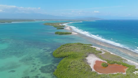 small green island in the bay of playa caobita in the dominican republic, aerial