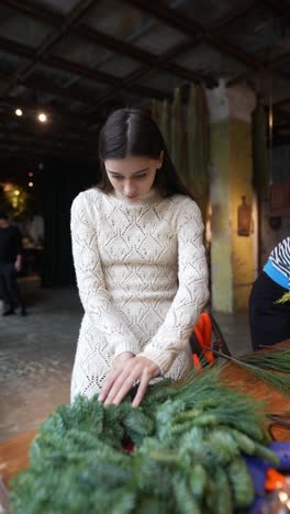 woman making a christmas wreath