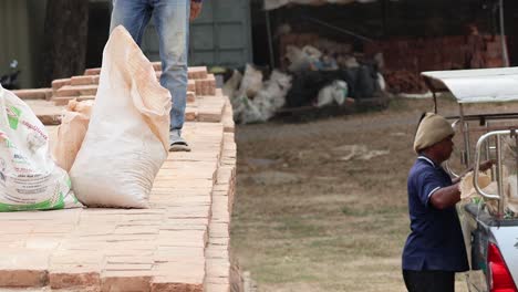 team of workers efficiently loading heavy sacks