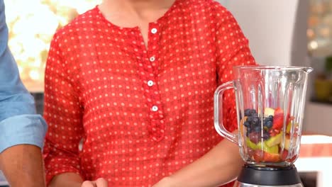 couple preparing smoothie together