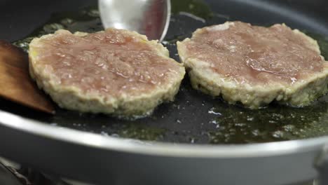 raw pork on hot gas stove with melt butter for testy and good smell prepare ingredients for making homemade burger.