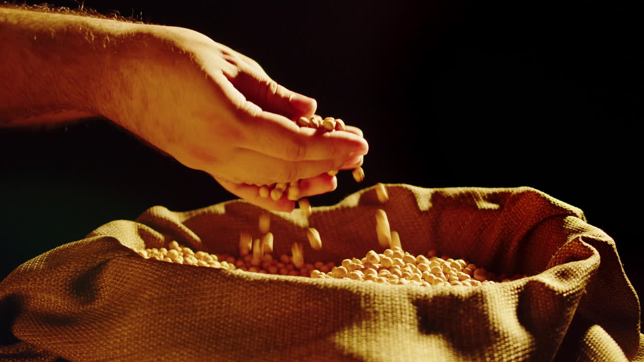 Hand Pouring Grains into Burlap Sack