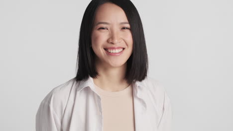 asian woman smiling in front of the camera.