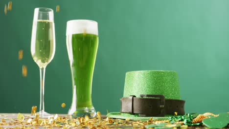 video of st patrick's glass of champagne, beer, hat with copy space on green background