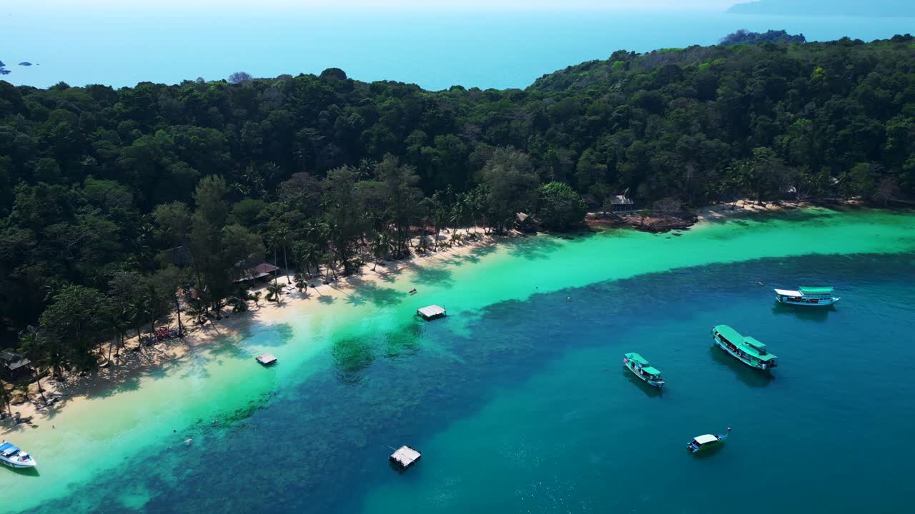 Koh Wai Bay Beach with boats anchored in turquoise waters. Gorgeous aerial view flight drone camera pointing down