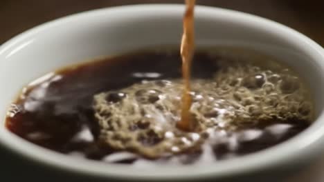 pouring espresso into a cup
