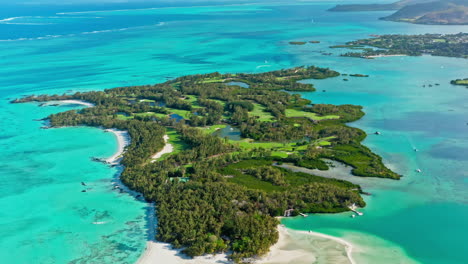 4k aerial drone shot flying away golf course at ile aux cerfs small tropical island at the mauritius with cristal clear turquoise water