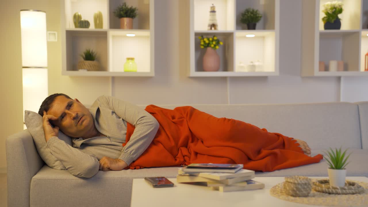Man lying in bed depressed.