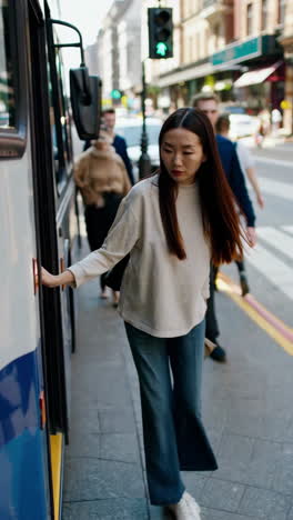 woman getting off a city bus