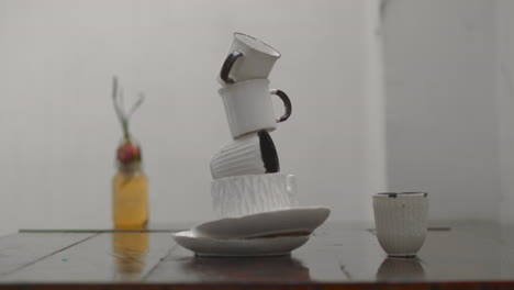 Rainy-outdoor-still-life-with-stacked-plates-and-cups