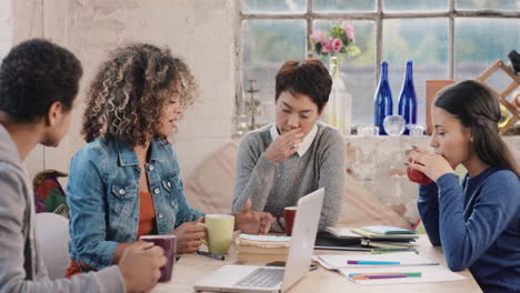 Diverse-group-of-students-studying-at-home-using-books-and-laptop-technology