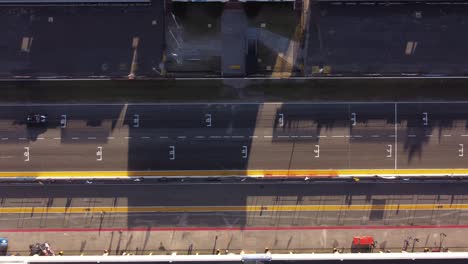 aerial drone left to right top view over vintage old cars driving on buenos aires race track automobile circuit