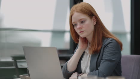 Thoughtful-concerned-redheaded-woman-working-on-laptop-computer-looking-away-thinking-solving-problem-at-office-serious-woman-search-for-inspiration-make-decision-feel-lack-of-ideas