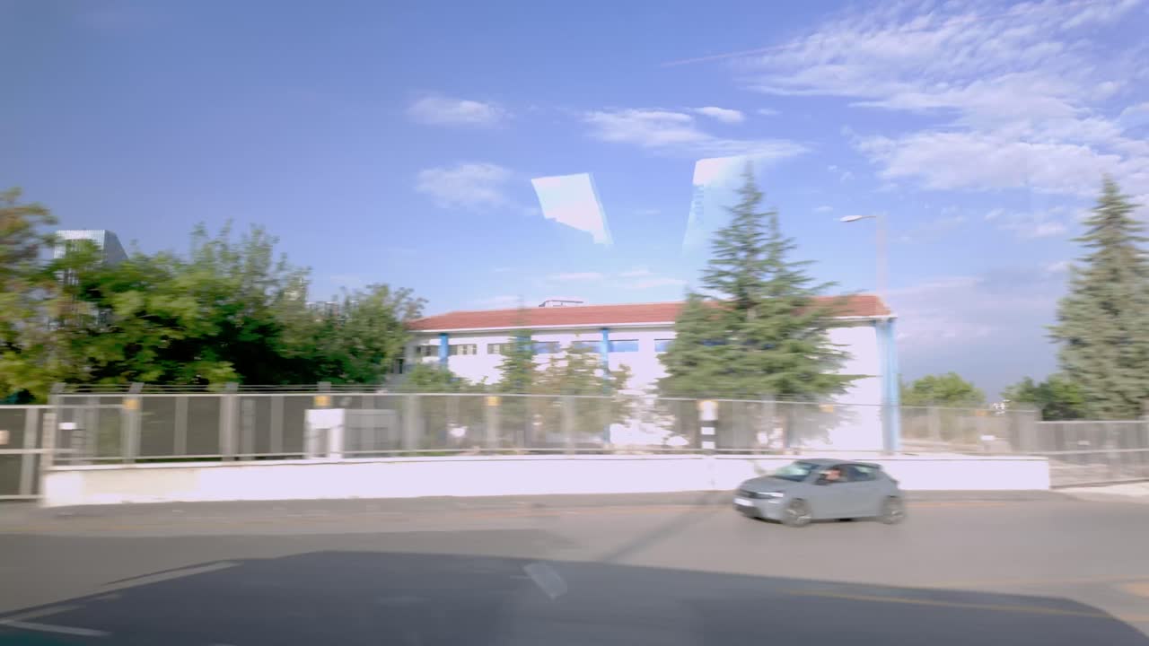 Driving Through a City on a Sunny Day