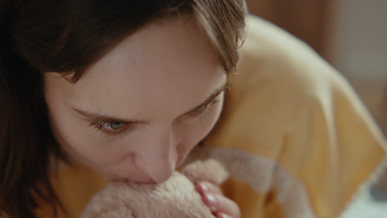 A girl playing with dolls in her room