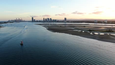 Looking-down-waterway-to-Surfers-Paradise-Low-tide-at-sunset,-with-exposed-sandbar