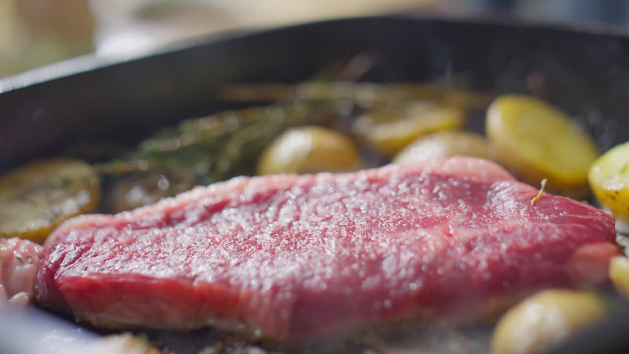 Steak and Potatoes being Cooked in Skillet