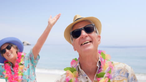 retired couple laughing on the beach