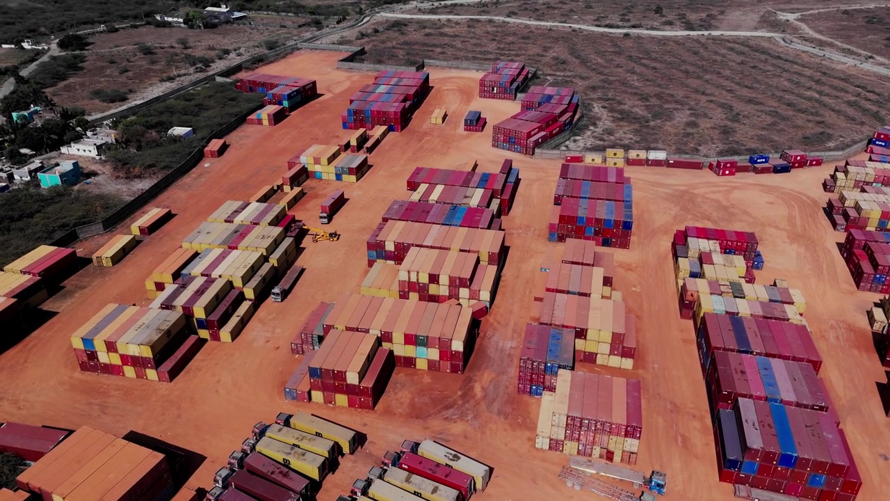 Aerial drone view of shipping container yard with stacked cargo containers and storage area near Chennai showcasing logistics freight and supply chain operations