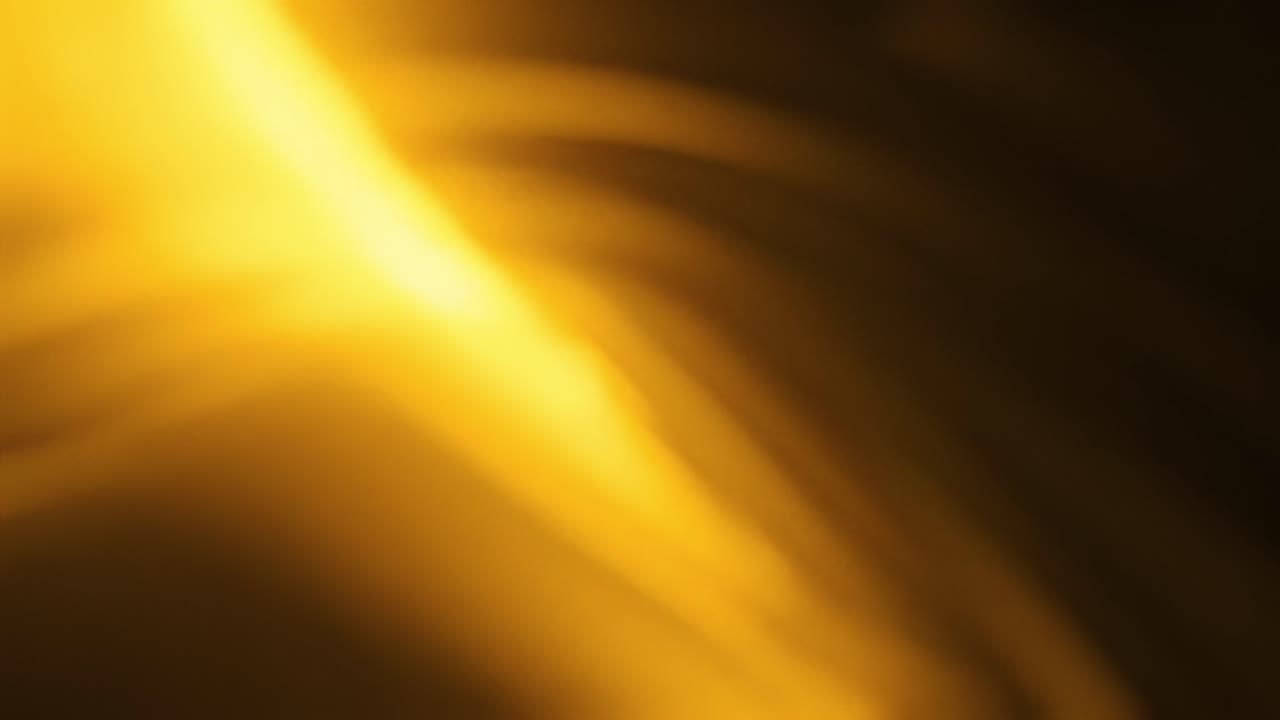 Soft waves of warm light ripple through a dark space, creating a captivating display. The fluid movements evoke a sense of tranquility and wonder, inviting viewers to relax and experience the visuals.