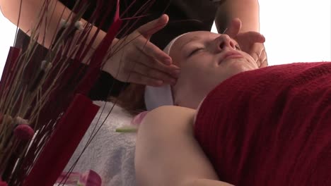 a woman receiving a facial massage