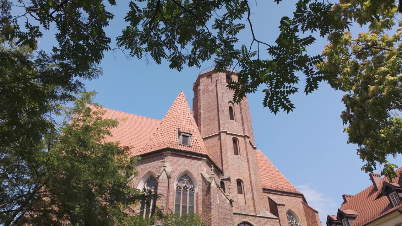 Establishing view of St. Matthew Church in Wroclaw, Poland, highlighting its gothic architecture and exterior