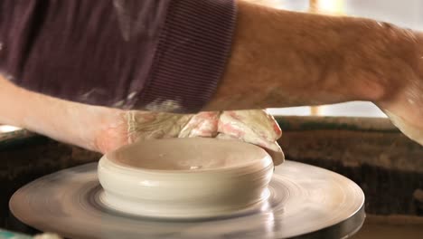 male potter making pot