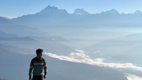 drone shot of nepal dolakha sailung, as a tourist walks through lush green hills, capturing breathtaking scenery, mountain ranges, and peaceful morning clouds near tibet eco-trekking and nature lover