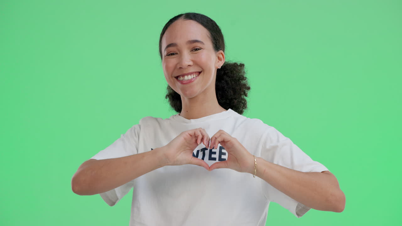 Woman volunteer making heart shape with hands