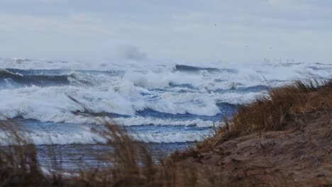 high baltic waves in slow motion crash into lone lighthouse during fierce storm