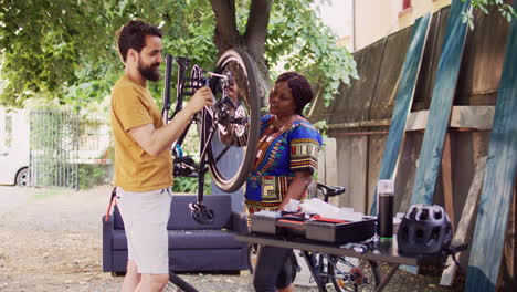 Couple-greasing-rusty-bicycle-chain