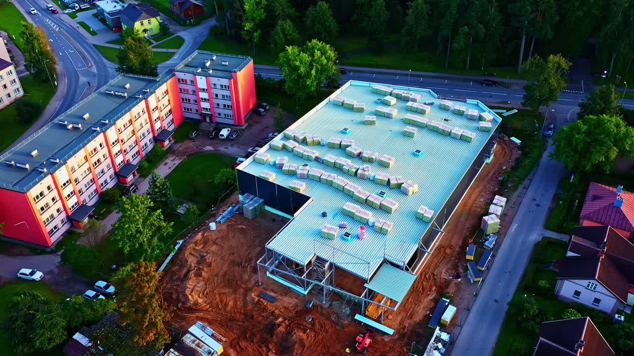 Aerial view of warehouse construction site next to apartment blocks